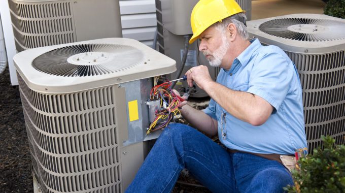 A Person Working On A Heat Pump